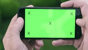  green screen,looking at the phone, hand , phone, tracking 