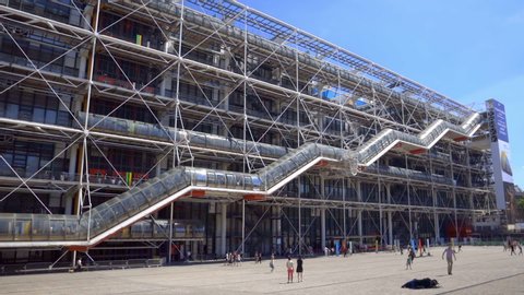 Paris, France - June 2019 :  Centre Pompidou Beaubourg in the center of Paris France, facade of the modern art and contempary museum with its famous colored pipes  and escalator on a spring day