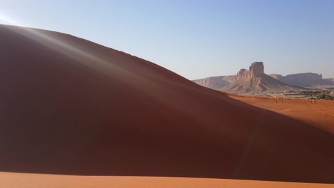 Beautiful desert landscape. Red sand dunes blown by the wind