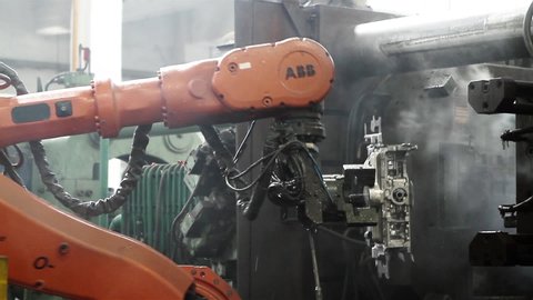Buenos Aires / Argentina - 05 27 2019: Industrial Robotic Arm working With Metal Part in the Factory. Original Sound.