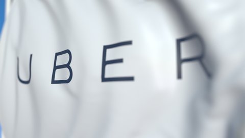 Waving flag with Uber Technologies Inc. logo, close-up. Editorial loopable 3D animation