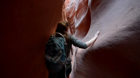 Woman Hiker Backpacker hiking narrow slot canyon