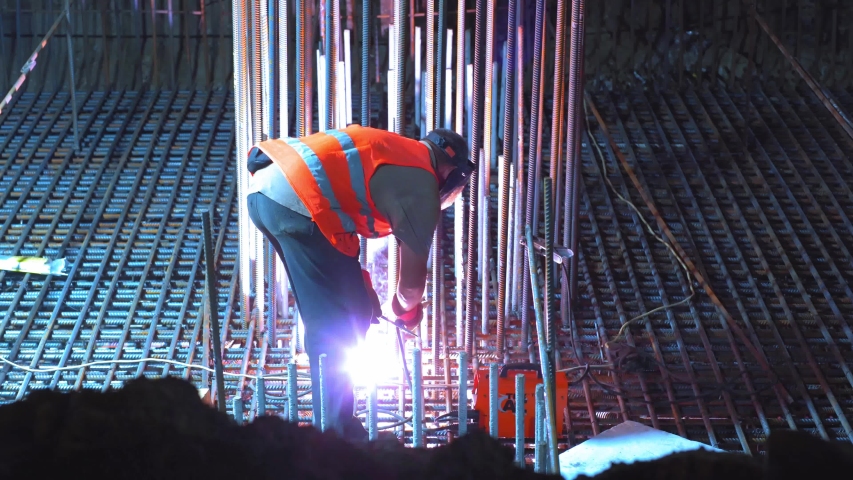 Construction site of Shulyavskiy bridge in Kyiv, Ukraine 6 of june 2019 Workers construct at night in led lights.