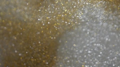 Slow motion of gold and silver glitter abstract background