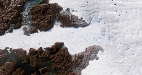 Very high-altitude overflight aerial of ice sheets and Jacobshavn Glacier, Greenland. Clip loops and is reversible. Elements of this image furnished by NASA