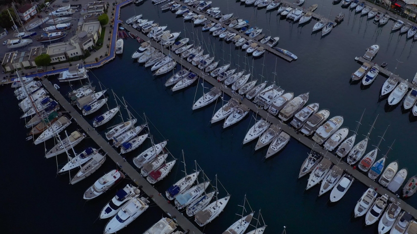 Fly over an elite yachts moored in the port eary in the morning. View from above 4k | Shutterstock HD Video #1031619635
