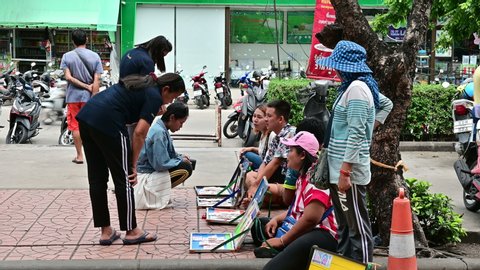 Phuket, Thailand - Jun 16, 2019 : Unidentified asian people buying lotteries