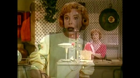 CIRCA 1960s - A blonde female operator complains about her boss to a redheaded female coworker, in an office, in 1965.