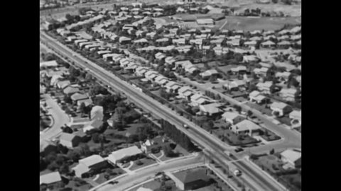 CIRCA 1960s - Overpopulation in the third world is a concern in the 1960's. Good aerials of suburbs and condom factory.