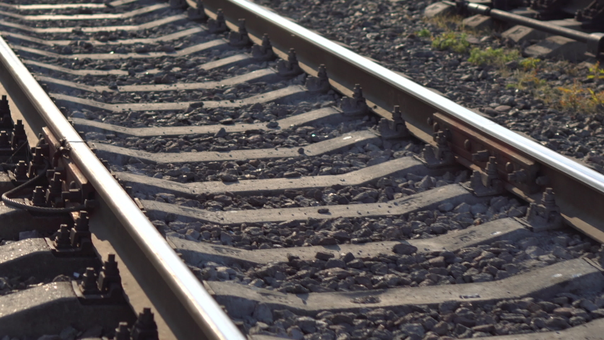 Railway rails and sleepers in summer sunny day. Close-up. Railroad track