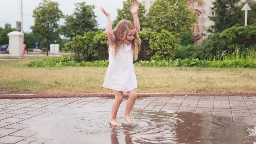 happy little girl dancing puddle white Stock Footage Video (100% ...