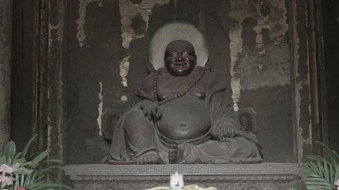 Statue of Biddist deitiy in the chinese temple.