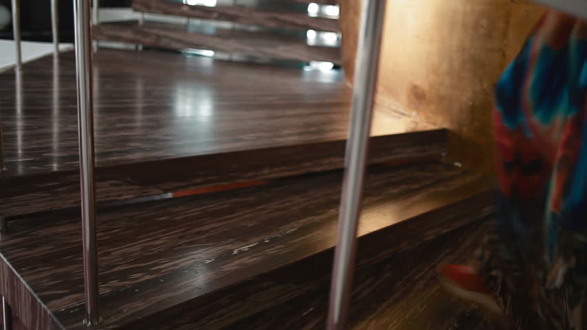 woman with heels and man on the modern stairs going up