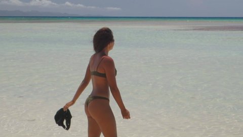 Slow Motion: Beautiful Woman in Bikini Walking Towards Camera with Ocean Behind - Cayo Arena, Dominican Republic