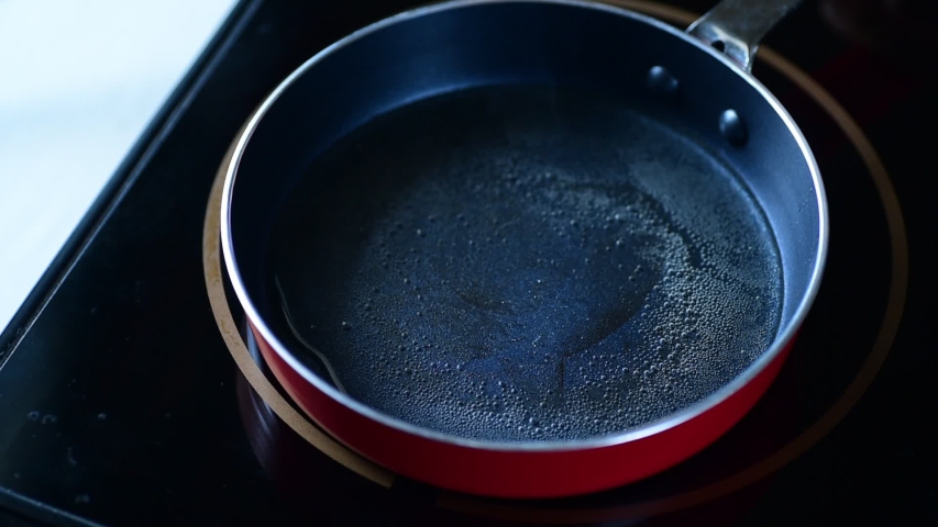 Omelette cooking with vegetable in a hot pan