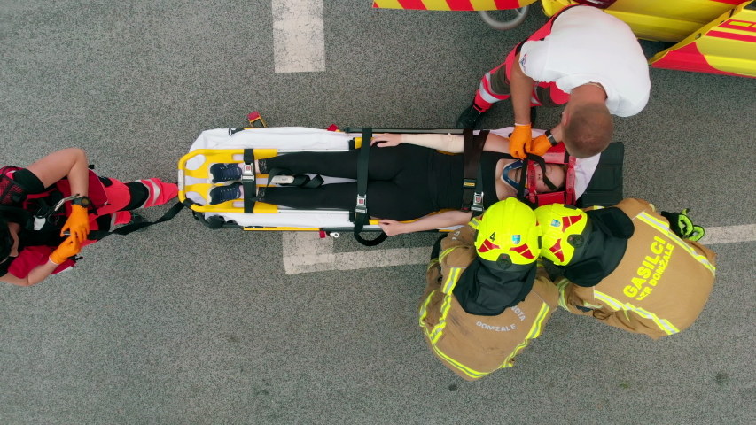 DOMZALE, SLOVENIA - 7. JULY 2015 Getting this injured person into the hospital as soon as possible. Aerial shot. A team of rescue workers is working as fast as possible.