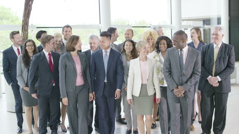 4K Portrait of large diverse business group smiling at the camera