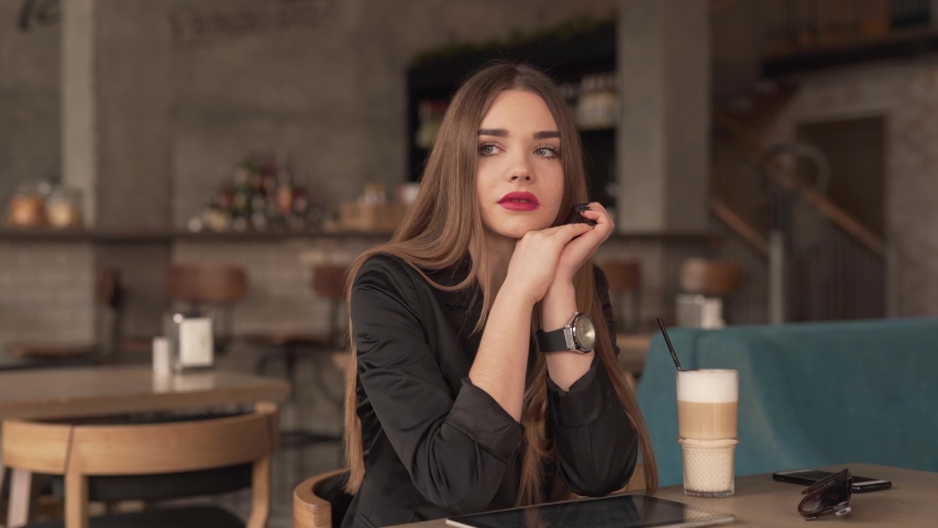 Brunette woman smiling in a cafe