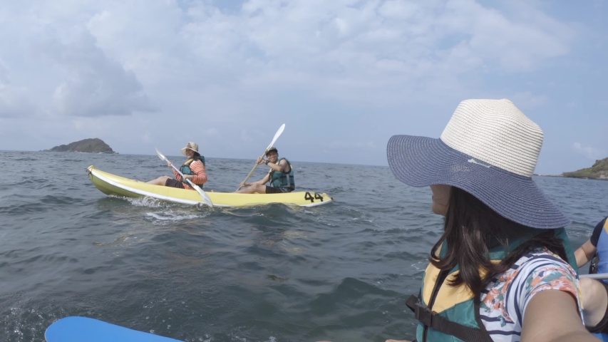 Group of adventurers kayaking around the Islands of Sattahip bay, Thailand.