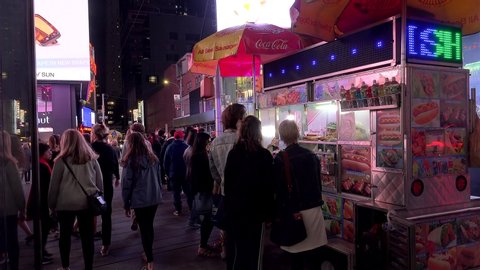 NYC, NEW YORK / USA - APRIL 23, 2019:
Customers at the Halal Food Cart on Times Square by night.