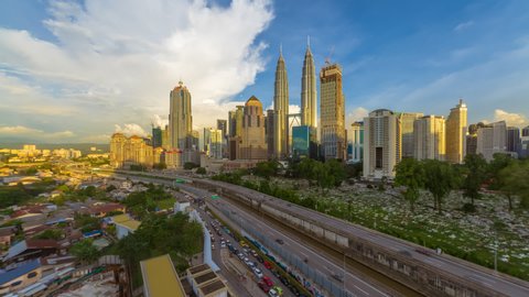 Time lapse of sunset in Kuala Lumpur city in Federal Territory, Malaysia overlooking a busy expressway.