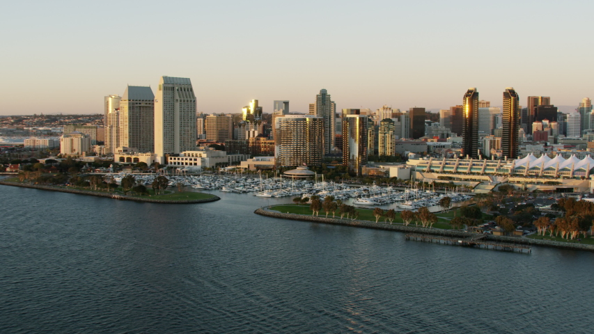 Aerial Waterfront sunset view of San Diego bay Embarcadero Marina Park North and South Convention Center Downtown city skyscrapers California USA RED WEAPON