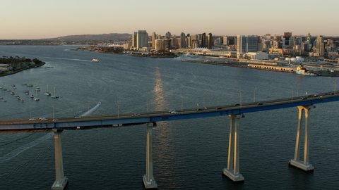 Aerial Waterfront sunset harbor view of San Diego bay Coronado bridge Embarcadero Convention Center Downtown city skyscrapers California USA RED WEAPON