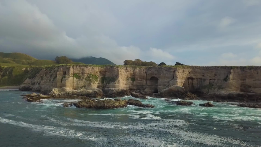 314 Big Sur aerial flying over the water closing up to the cliffs