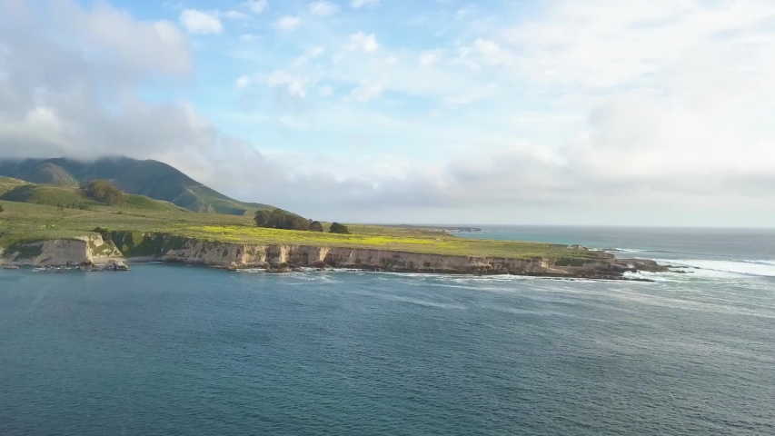 309 Big Sur aerial flying over the water reveling cliffs and mountains