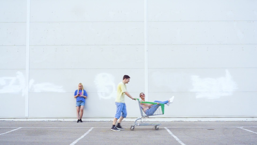 Group of young people having fun around mall parking lot