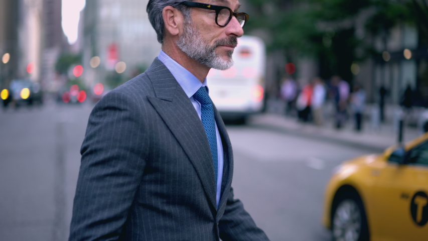 Confident mature financial director of company dressed in elegant luxury suit strolling to business meeting with colleague in office building, concept of successful lifestyle | Shutterstock HD Video #1031702351