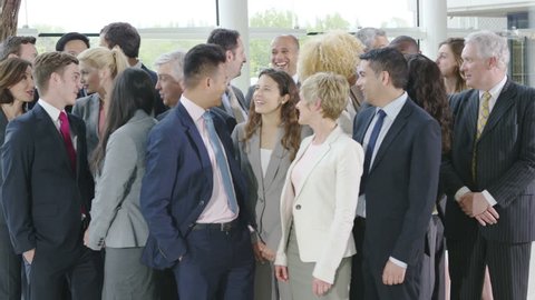 4K Portrait of large diverse business group smiling at the camera
