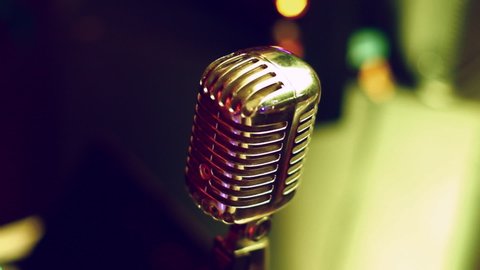 Vintage microphone in a retro club. Spotlight glare. close-up