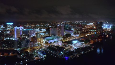 NORFOLK, USA - JUNE 13, 2019: Norfolk skyline by night with slow camera rotation. Norfolk is the second-most populous city in Virginia and the host of the largest navy base in the world