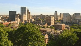 Late afternoon drone footage of Providence, Rhode Island with uplift camera motion from Prospect Terrace park, revealing the city skyline. Providence is the capital of Rhode Island.