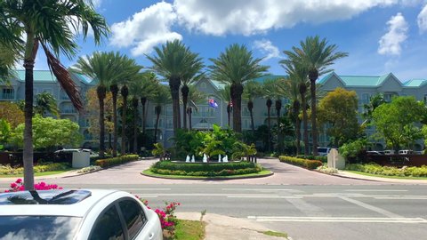George Town, Grand Cayman, Cayman Island, April 28, 2019: Exterior of the Westin Grand Cayman Seven Mile Beach Resort & Spa with flags and palm trees. 