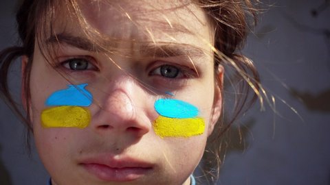Portrait of a boy with the Ukrainian flag on the face of body painting, 4 video. 