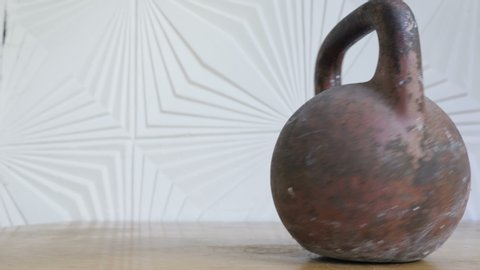 The rotation of the kettlebell for strength training on the table 

