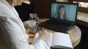 Online Psychologyst Therapy Session in a Coffee Shop. Female Psychologist Consulting a Client via Video Call