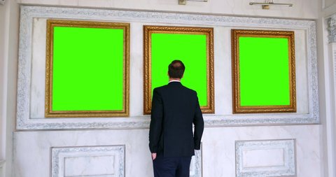 Back view of man observing painting in art gallery - Image. Green screen, slow motion, chromakey