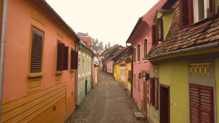 Beautiful view of the colorful houses and the old stone paved street of the famous Sighisoara medieval town. Transylvania Romania. Aerial view travelling