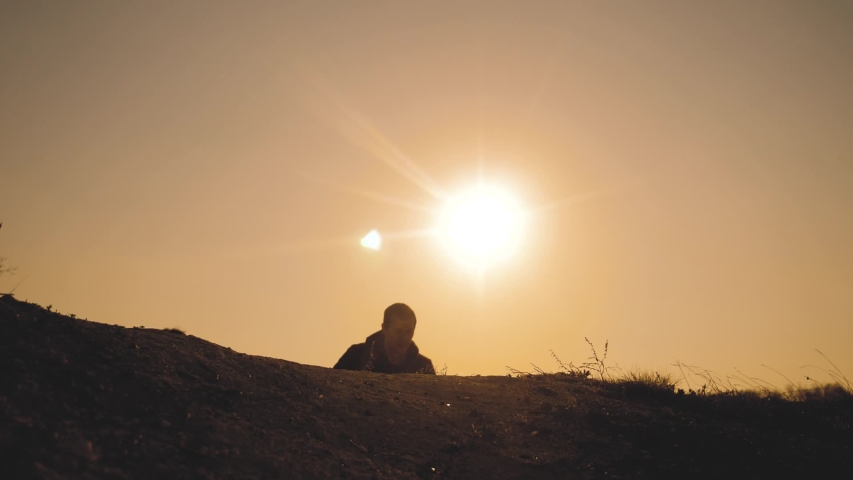 teamwork business travel concept. legs silhouette group hikers of people walking on the top of the mountain with backpacks sunset sun light. slow motion video. campaign tourists with backpacks