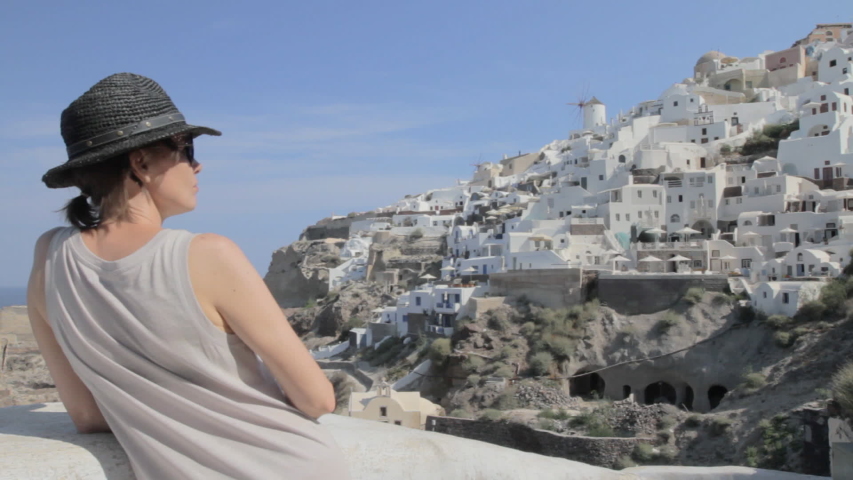 A woman is looking at the view in Santorini.