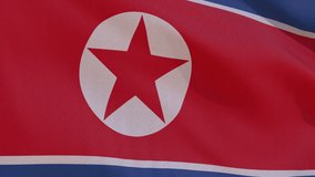 This video shows beautiful animation of the national flag of the Democratic People's Republic of Korea with highly detailed fabric texture, waving in slow motion. 4k seamless loop