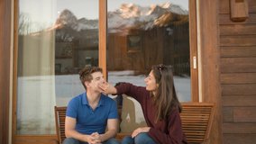 Young Woman Helps Man Apply Sunscreen Outside Ski Chalet. - Powered by Shutterstock - Get 15% off with code: PIKWIZARD15