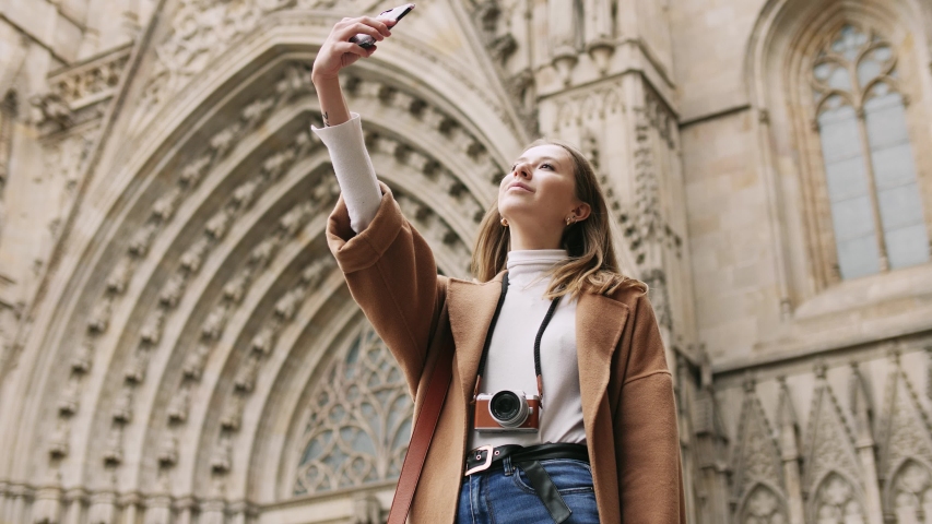 A beautiful young girl making a selfie during walk