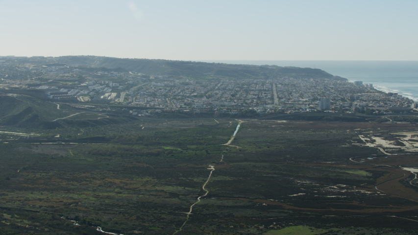 Aerial view of International Park between the United States and Mexican Border wall Pacific ocean near Monumental Tijuana Mexico RED WEAPON