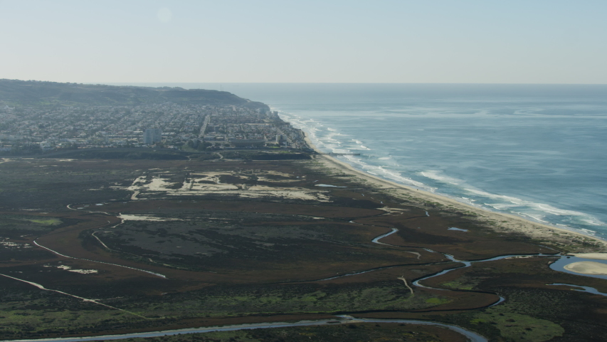 Aerial view of International Park between the United States and Mexican Border fence Pacific ocean near Monumental residential suburbs Tijuana Mexico RED WEAPON
