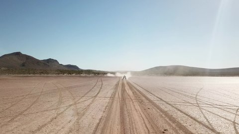 Off Road vehicle racing on dry lake bed in Baja Mexico