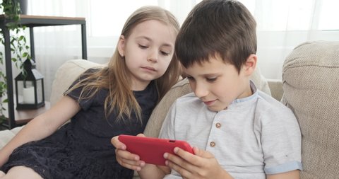Children playing game on mobile phone 